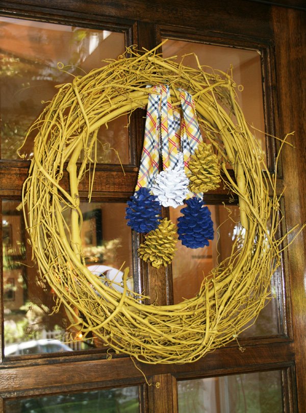 modern nature inspired party with a curry yellow pine cone wreath