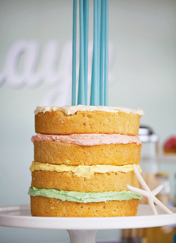 pastel layer cake with tall candles