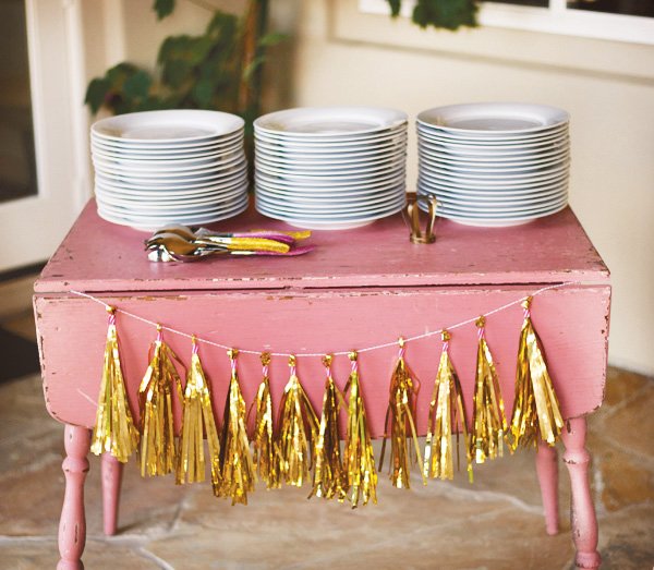 gold tassel plates on a vintage pink table
