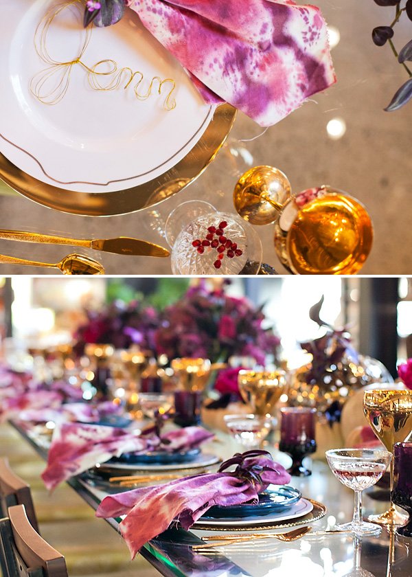 The finished DIY wine-splattered napkins paired with a modern glam gold tablescape