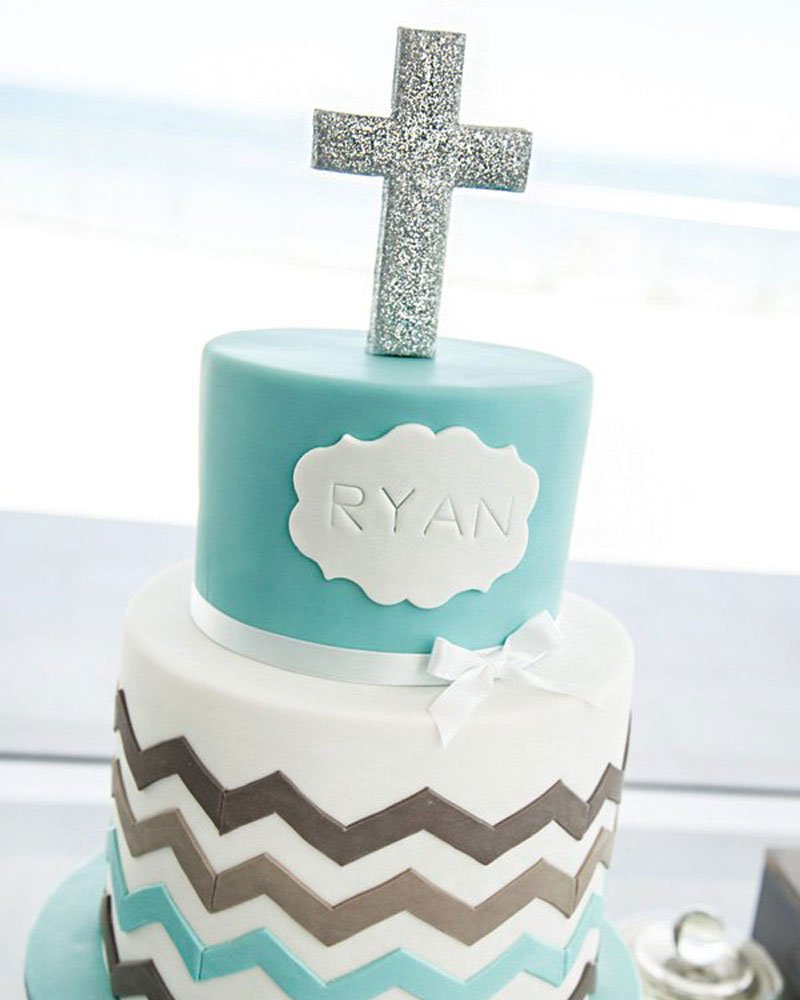chevron striped christening cake topped with a silver glitter cross topper