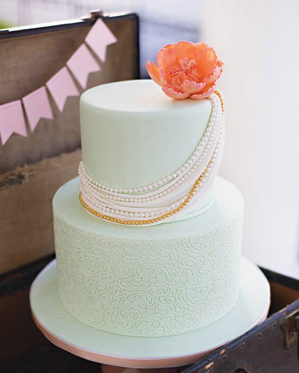 pearl draped mint wedding cake with a coral flower topper